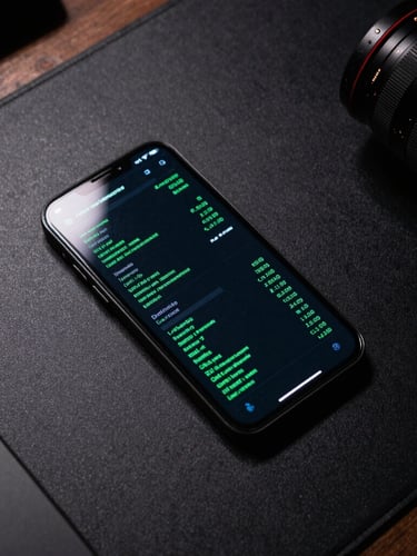 Top-down overhead shot of a physical Android device on a matte black developer desk, displaying a high-contrast terminal-style interface with green metrics, sharp directional light highlighting the glass edges.