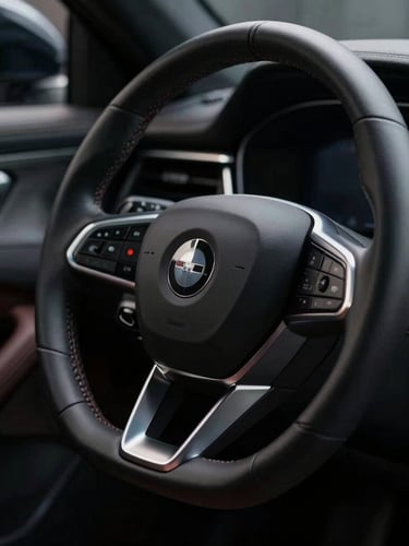Sleek automotive design detail, close-up of a luxury steering wheel and dashboard in low-key dramatic lighting, deep shadows, silver accents, 35mm lens