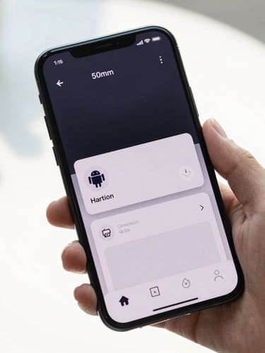 Close-up of a hand holding an Android phone displaying a clean, dark-themed system monitor app under bright natural daylight.