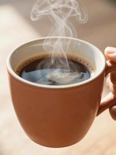Close-up of a hand holding a steaming terracotta mug filled with coffee, bright morning sunlight, warm editorial photography, 35mm lens