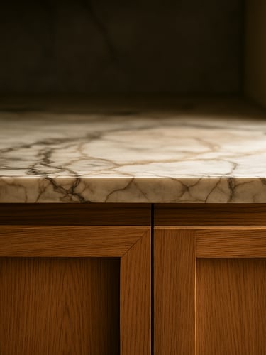 Close-up of custom oak joinery and rich marble veining in a modern kitchen, soft directional afternoon light, medium format film style
