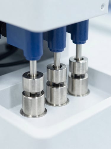 Clinical laboratory photography, bright high-key sterile white light, close-up of high-performance liquid chromatography columns with precise stainless steel fittings, sharp focus, 50mm
