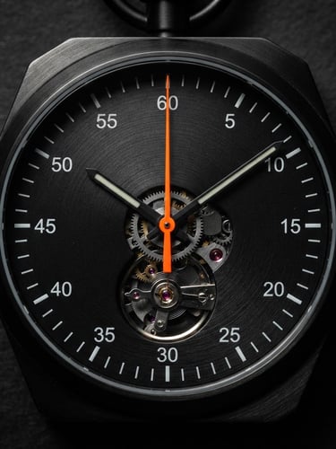 Tight macro shot of a sleek black mechanical stopwatch, sharp directional light casting dramatic shadows, a single bright electric orange second hand pointing to the top, dark charcoal background, 50mm