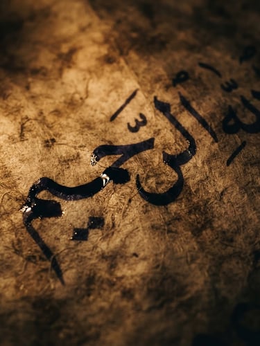 Extreme close-up macro shot of ancient Arabic parchment, ink drying slowly on textured paper, low-key warm candlelight, high contrast chiaroscuro, 35mm