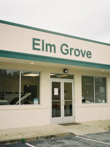 A quiet, warm-toned editorial photograph of a physical therapy clinic exterior in Elm Grove, Wisconsin, soft overcast daylight, 35mm film style