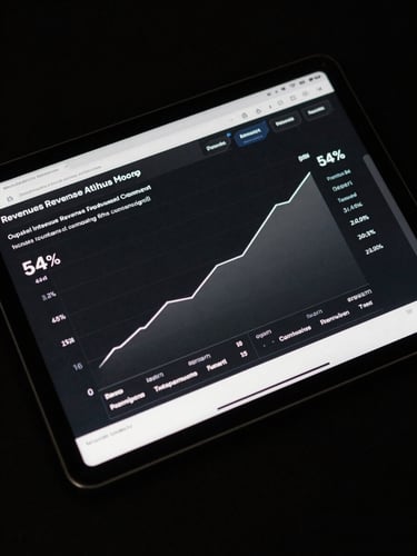 Overhead shot of a tablet displaying a local retail revenue attribution dashboard, a clear line graph showing monthly revenue climbing 54% after integrated campaign launch, dark near-black surface, sharp even lighting on the data