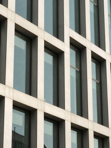 A sharp, high-contrast black and white architectural detail of a modern corporate office facade, geometric steel lines, bright natural daylight, clean composition
