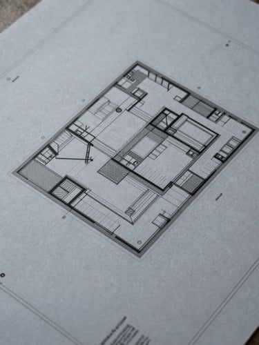 Overhead shot of architectural blueprints on a drafting table, precise lines, diffused light, slate tones.