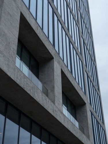 Architectural detail of a modern financial hub in Salt Lake City, sharp concrete and glass angles reflecting cool overcast daylight, 35mm lens, minimalist editorial style