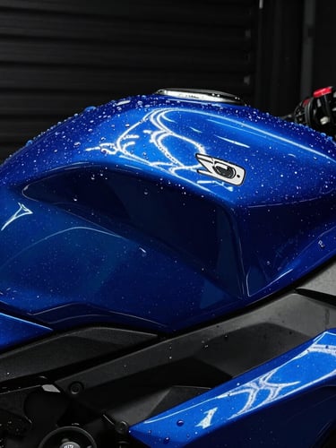 Dramatic close-up of water beading on a freshly polished electric blue motorcycle tank, neon reflections, dark garage backdrop, macro lens, 35mm