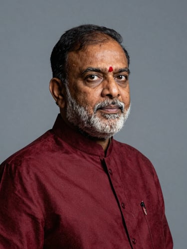 High-contrast editorial portrait of a prominent Indian public figure in motion, dramatic studio lighting, deep crimson and cool gray tones, sharp 35mm lens, negative space on the right.