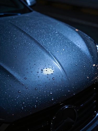 Macro close-up of water beading on a glossy ceramic coated car hood under sharp blue LED studio lights, high-contrast, moody automotive photography, 35mm