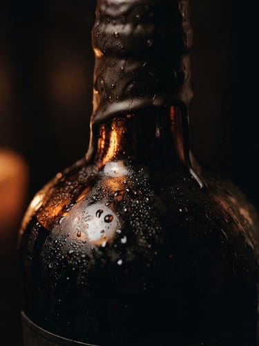 Tight macro shot of candlelight reflecting off a wax-dipped bottle of amaro, condensation beads on dark glass, deep shadows, amber glow, 35mm film grain