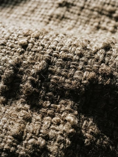 Macro detail shot of heavy-weight raw linen fabric under high-contrast natural window light, deep shadows emphasizing the thick unrefined weave structure, 35mm
