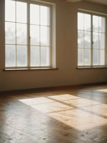A quiet sunlit meditation hall with wooden floors, soft morning light streaming through high windows, peaceful atmospheric setting, warm tones, 35mm film look.