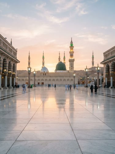 Serene dawn light reflecting on the polished marble courtyard of the Prophet's Mosque in Madinah, wide angle, soft golden hour glow