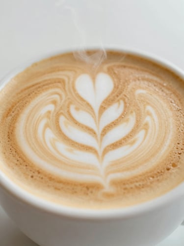 A close-up of a perfectly poured latte with elegant rosetta art, steam gently rising in soft morning daylight, warm cream tones, 35mm editorial photography