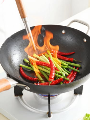 Close-up of a chef wok-firing fresh vegetables and red chilies, bright high-key lighting, motion blur of fire, clean kitchen setting