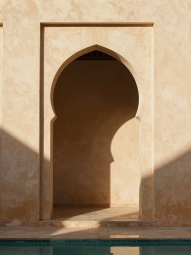 Cinematic portrait of a minimalist Moroccan courtyard, sharp geometric shadows slicing across warm ivory tadelakt walls, soft sunlight filtering through an archway, serene water reflections.