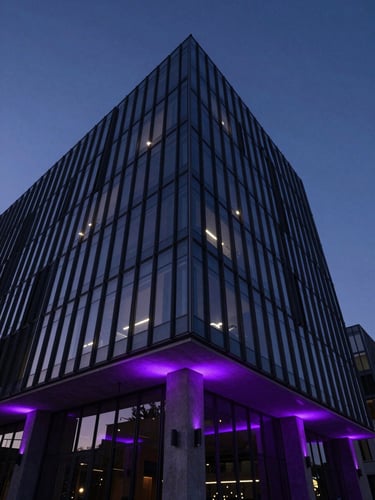 Dramatic low-key architectural shot of a modern glass tech headquarters at dusk, deep violet ambient rim lighting reflecting on sharp concrete edges, high contrast, 35mm