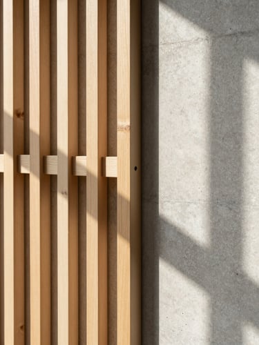 Abstract detail shot of a timber screen join against raw concrete wall, soft morning sun casting long clean architectural shadows, 35mm lens