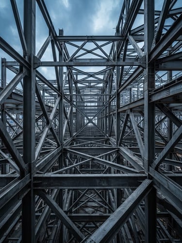 Wide-angle view of a massive structural steel framework under a cool overcast sky, razor-sharp focus on the intersecting beams, high contrast, no people.
