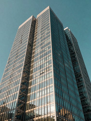 Low angle panoramic shot of high-altitude corporate architecture in São Paulo, sharp glass reflections against bright daylight, deep teal sky tones, 35mm lens.