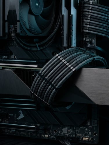 Extreme close-up macro shot of pristine, clean cable management in a high-end PC build, cool-toned studio lighting, subtle cyan rim light, deep obsidian background, geometric edges