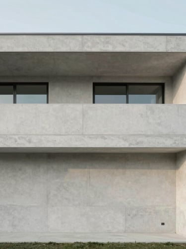 Wide architectural crop of a minimalist modern home facade, clean concrete lines, soft natural daylight, muted cool tones, 35mm