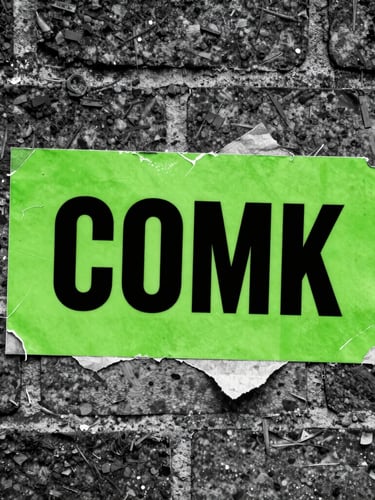 Extreme close-up, high-contrast black and white flash photography of a physical brand asset (e.g., a gritty, worn-out, acid-green branded sticker peeling off a brick wall in a Birmingham alley), direct harsh light, wide-angle lens, brutalist aesthetic.