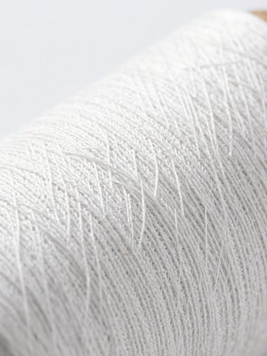 Macro photography of woven cotton textile fibers under clean bright clinical lighting, high thread count texture detail