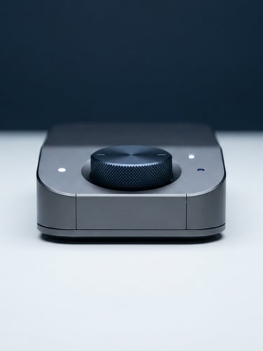 Sleek physical tech hardware device on a clean white surface, cool studio lighting, deep navy ambient fill, sharp macro focus, 85mm