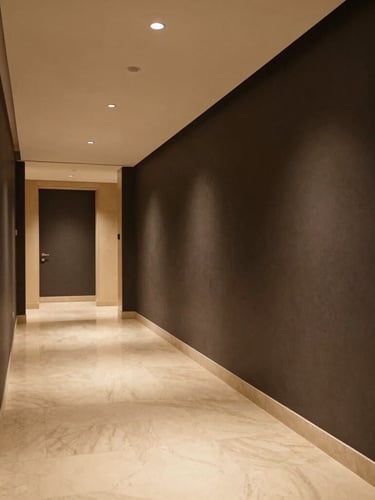 Architectural shot of a luxury hotel corridor with soft ambient lighting, high-contrast editorial design, deep charcoal walls, warm champagne accents