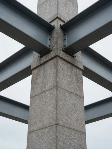 Symmetrical architectural close-up of a granite pillar and steel beams, overcast daylight, sharp structural lines.