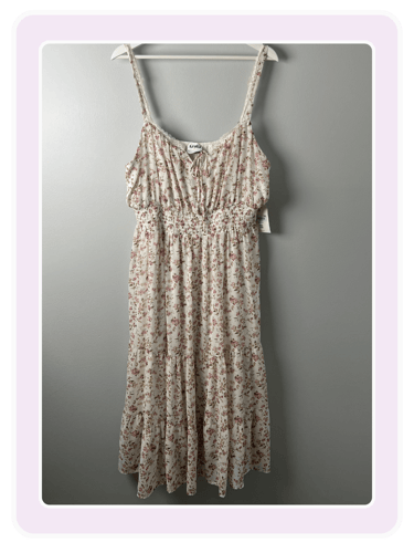 Arula floral smocked midi dress with adjustable straps and a tiered skirt on a hanger.