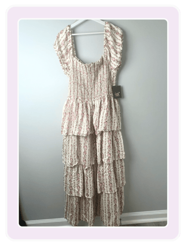 Lark and Grey floral print tiered maxi dress with smocked bodice and puff sleeves on a hanger.