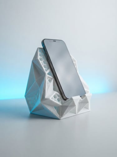 Bright high-key studio photography of a geometric 3D printed phone stand on a clean light gray desk, vibrant electric blue neon ambient backlighting, sharp macro details of the printed layers, 35mm lens