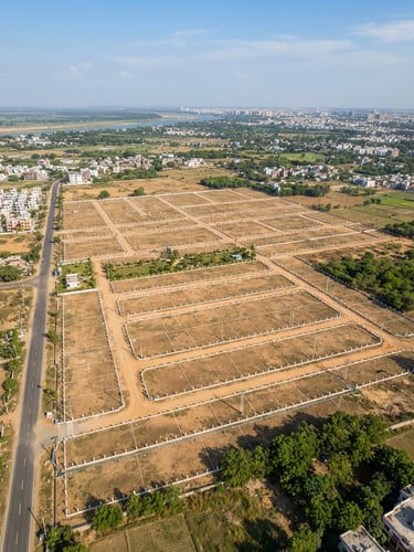 Overhead drone photography of a neatly plotted residential land development in Patna, clear boundary markers, bright natural daylight, warm earth tones