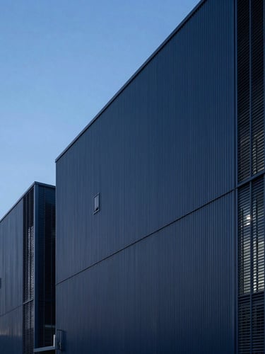 Crisp architectural photography of a modern industrial facility under cool blue hour lighting, sharp focus, clean lines, negative space on the left