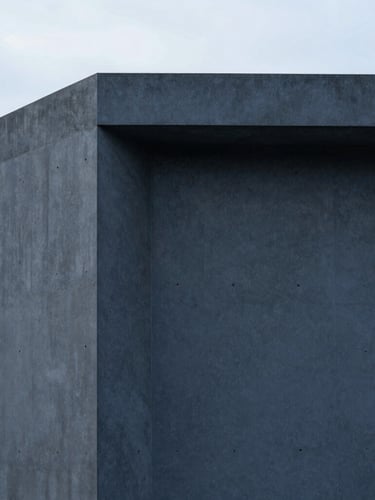 Minimalist concrete architectural detail with clean lines and soft shadows, overcast daylight, deep slate tones, sharp focus, 35mm