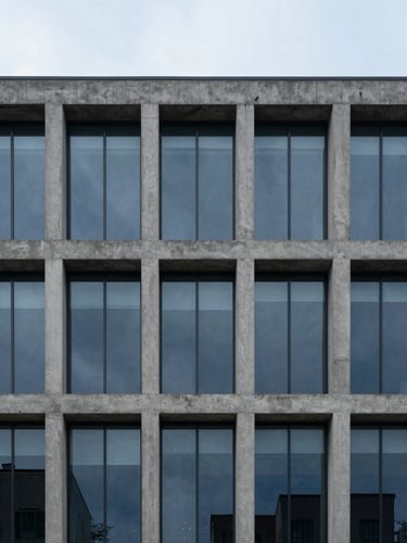 Straight-on architectural detail of a modern concrete and glass building facade, soft overcast daylight, cool slate tones, sharp focus.