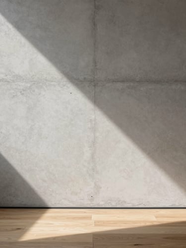 Close-up of raw concrete wall meeting a warm oak floor, soft morning light casting a geometric shadow, Hasselblad medium format.