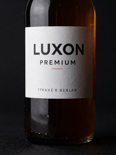Moody dark product photography of a dark amber glass bottle of LuXon Premium catching sharp amber rim light, deep black background, high-contrast, macro lens, 35mm