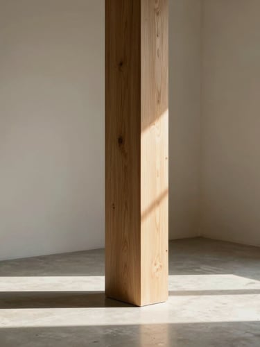 Vertical portrait of a minimalist corner with a raw oak column, cast concrete floor, and soft natural light casting long shadows