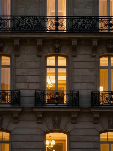 Architectural details of a Parisian luxury hotel facade at dusk, warm glowing window light, limestone textures, dark cinematic luxury photography