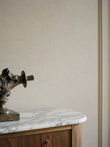 Close-up portrait of a meticulously detailed interior, showing a corner with a bespoke marble console, an antique bronze sculpture, and a textured linen wall covering, soft ambient light, elegant composition, medium format film.