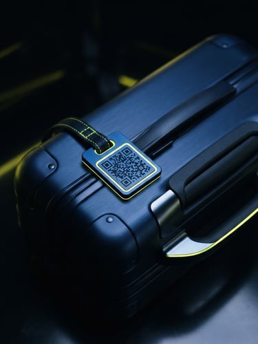 Sleek close-up of a designer suitcase with a premium midnight blue QR tag, high-contrast studio lighting with neon yellow edge-glows, sharp focus, 35mm