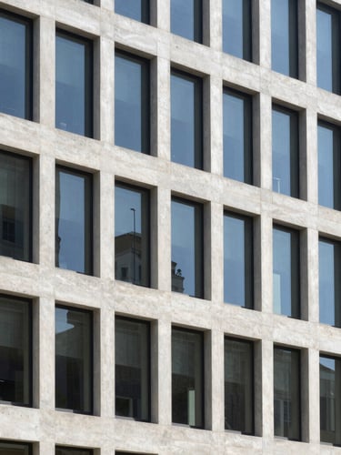Crisp architectural lines of a modern concrete and glass office building, bright natural daylight, slate tones, 35mm photography