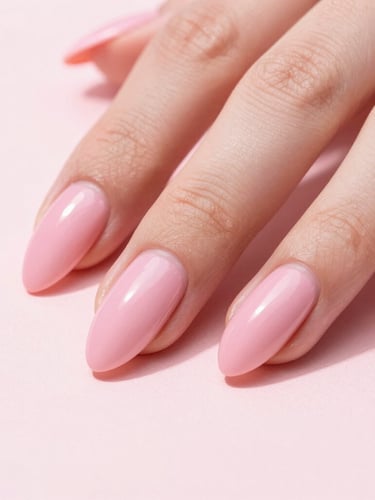 Macro shot of a hand with long, high-gloss pink almond nails resting on a clean blush surface, bright studio lighting