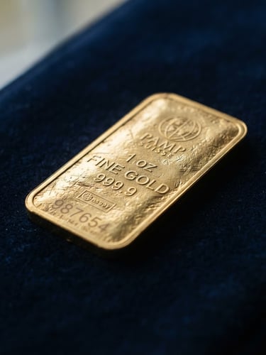 Macro close-up of a minted physical gold bullion bar resting on a dark navy surface, soft natural window light highlighting the heavy metallic texture, shallow depth of field